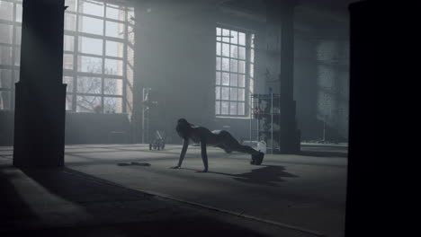 athlete doing press ups during workout. woman making functional training