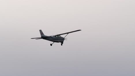 small propeller airplane flying, sky background