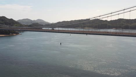 aerial shot revealing bridge over japan inland sea in summer