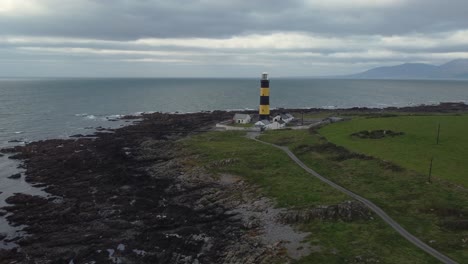 Aerial-view-of-St-John's-Point-lighthouse-on-a-cloudy-day,-County-Down,-Northern-Ireland