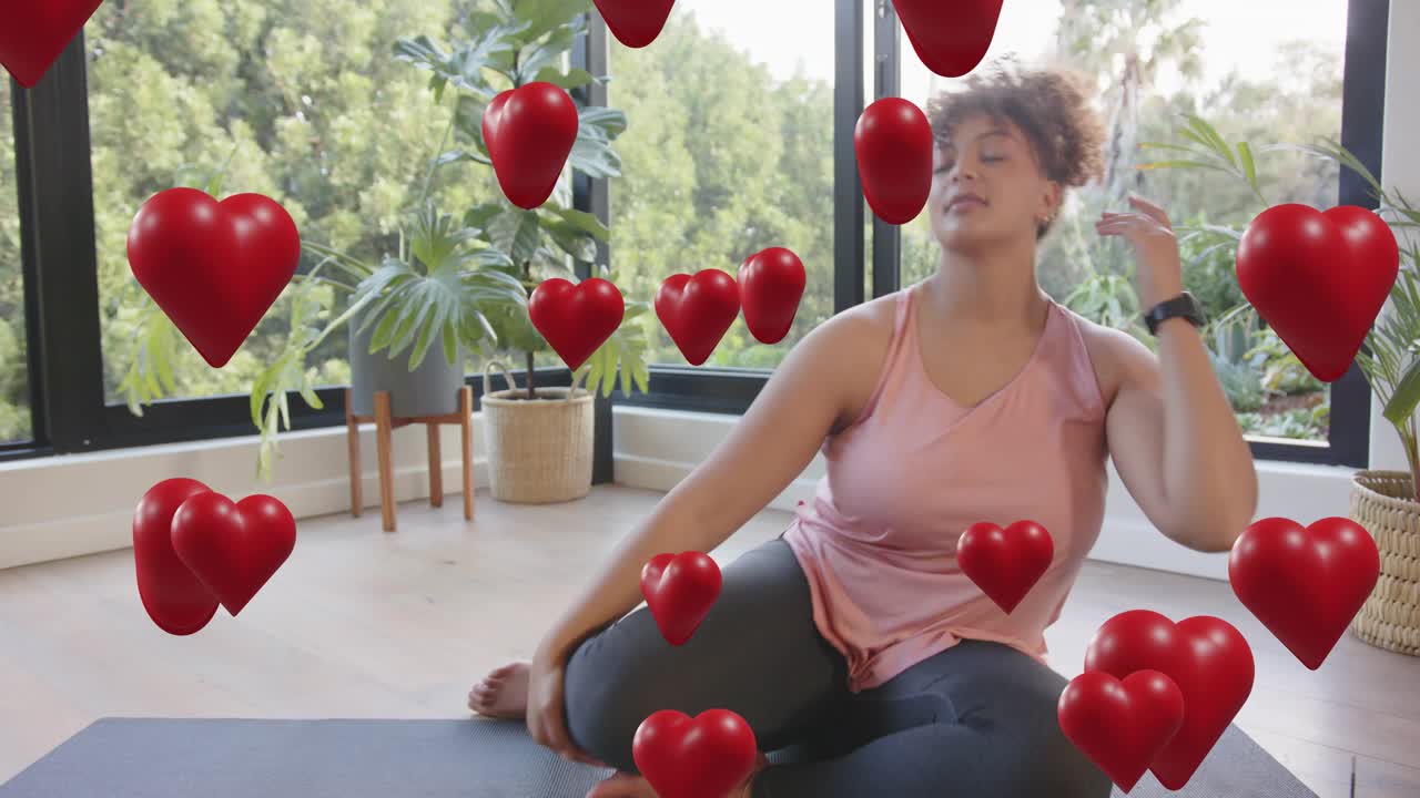 Woman stretching on mat by windows, hearts appearing and causing head turning, smiling for fitness