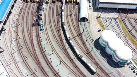 Cinematic-aerial-of-subway-train-leaving-train-yard