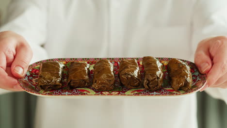 chef serving a tray of dolma