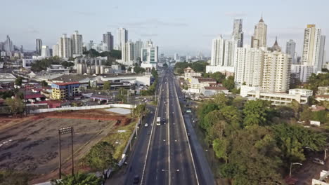 aerial shot dolly in 4 lane avenue with buildings in panama city, panama