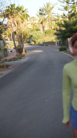 woman running on a street with palm trees