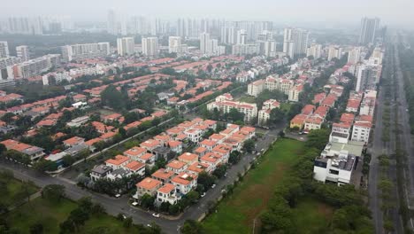 drone dolly above foggy moody haze clouds above apartment buildings in vietnam