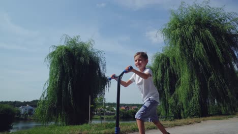 a boy rides a scooter in a city park 15