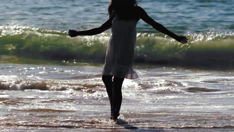 silhouette of woman revolving in waves