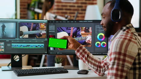 african american man edits a music video at his home office next to copy space