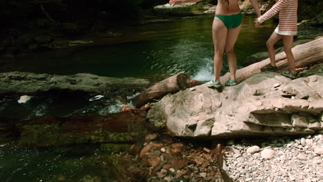 mother and daughter enjoying a summer day by a creek