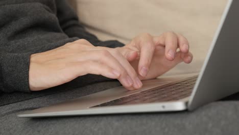 Female hands and fingers above notebook touch pad close-up 4K video
