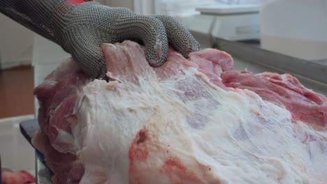 butcher cutting raw pork