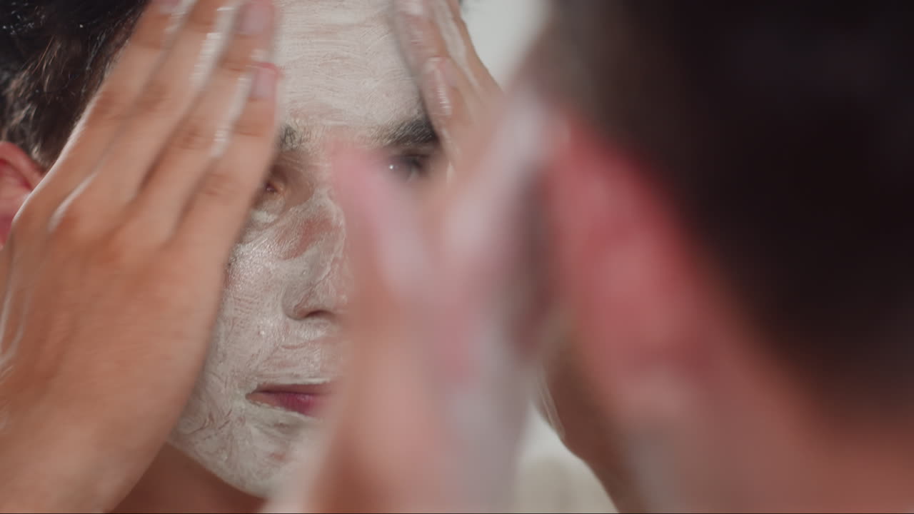 Male Zoomer Putting on White Anti-age Mask on Face