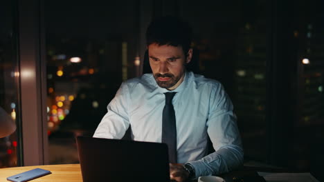 confused entrepreneur looking laptop monitor sitting office late evening closeup