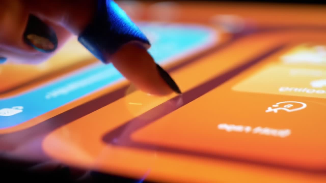 Close-up of a Hand Using a Stylus on a Touchscreen, Interactive Interface Engaging with Colorful Buttons and Icons for Digital Navigation
