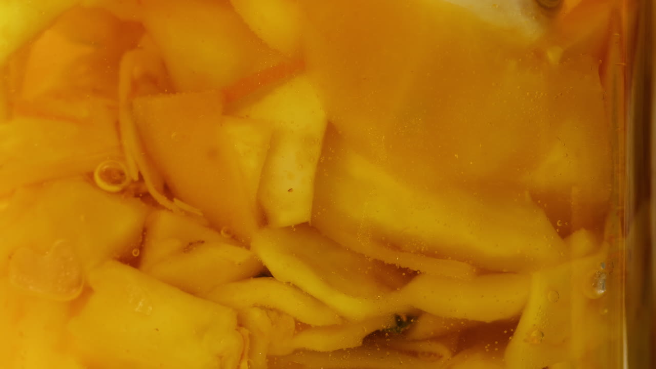 Close-up of fermented yellow cabbage in can. Preservation of vegetables in glass jars. Fermentation preserved vegetables. Sauerkraut with spices.