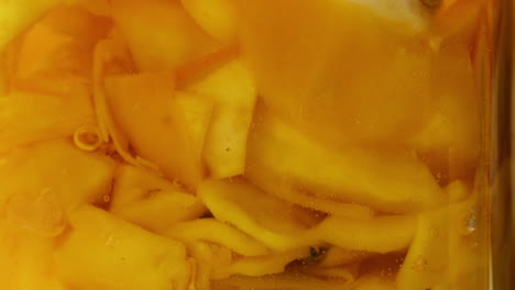 close-up of fermented yellow cabbage in can. preservation of vegetables in glass jars. fermentation preserved vegetables. sauerkraut with spices.