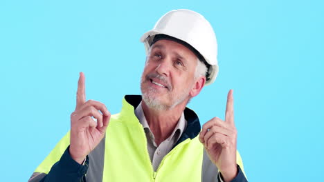 construction worker pointing upwards on blue background