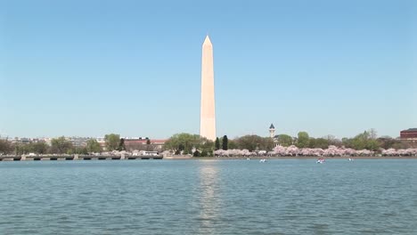 the washington monument reflects across a shimmering body of water