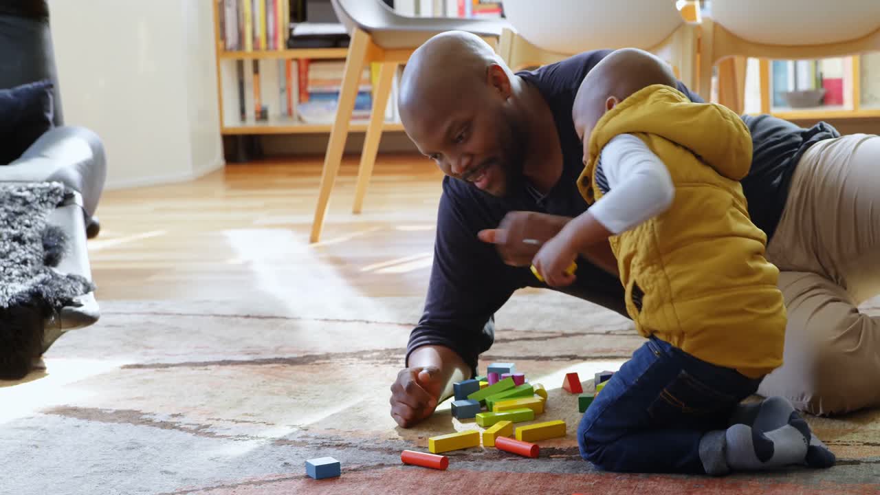 Father and son playing with building blocks 4k