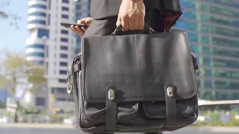 businessman holding a business briefcase.