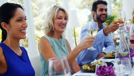 group of friends toasting glasses of wine