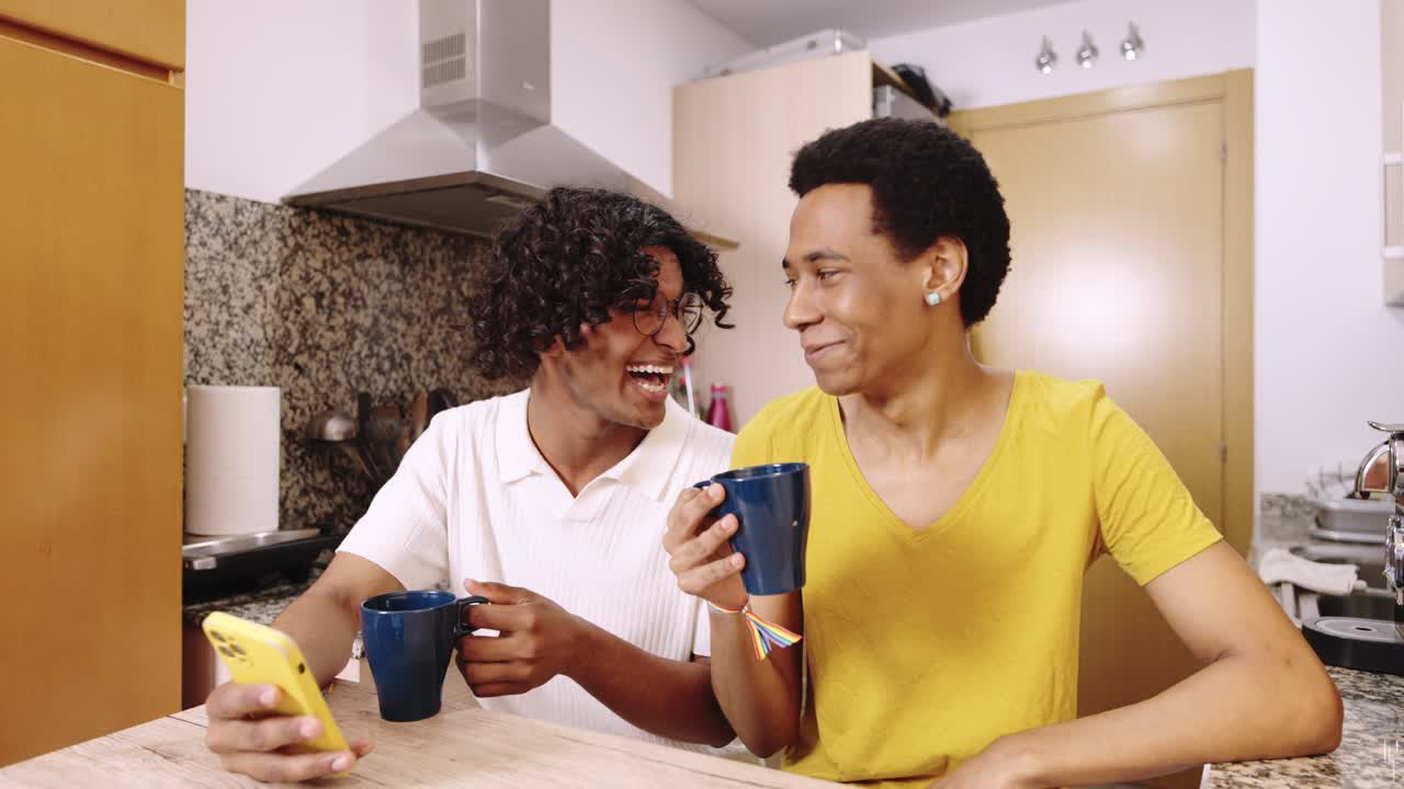 Two Men Enjoying Coffee and Mobile Phone in Kitchen