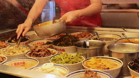 vendor preparing diverse dishes at food stall