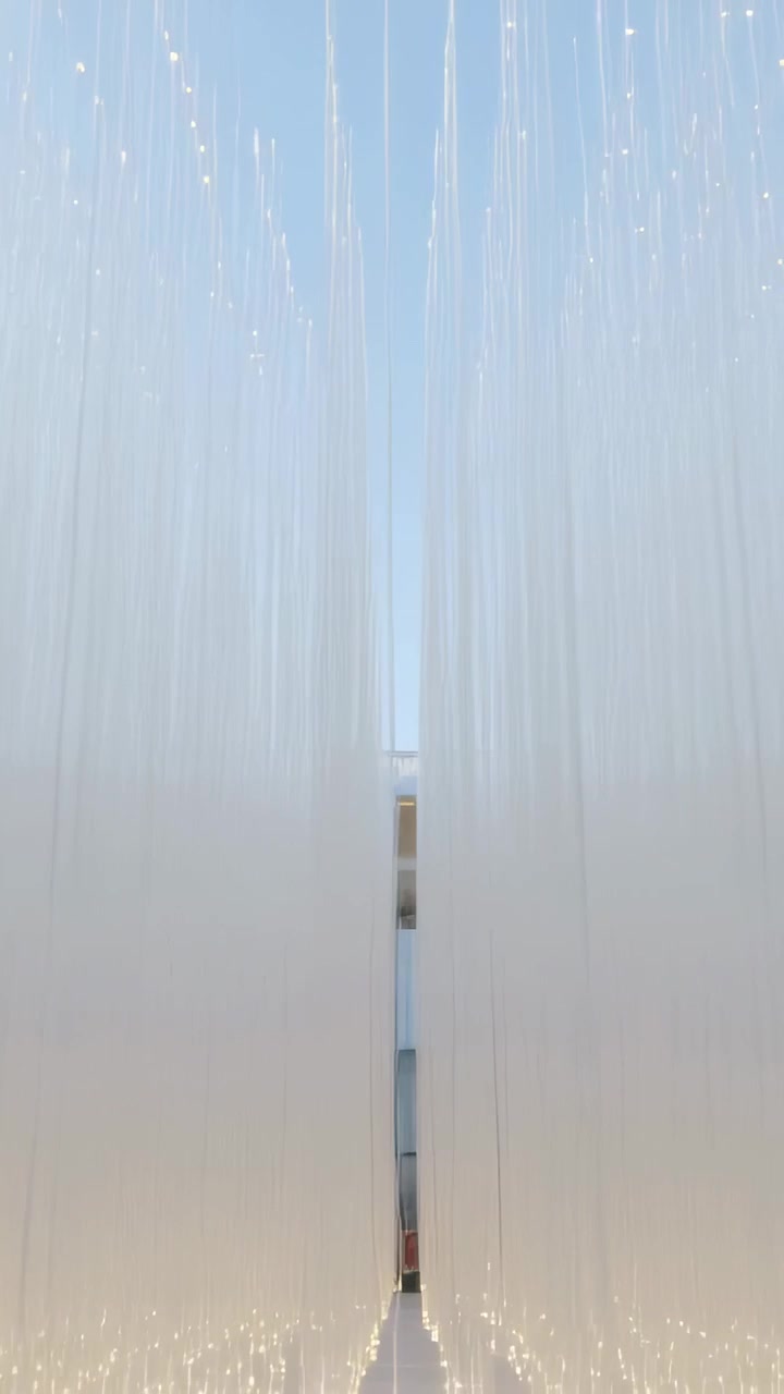 Video verticale: La telecamera in movimento rivela una tenda in fibra e una porta lontana in un corridoio, con luci a LED.