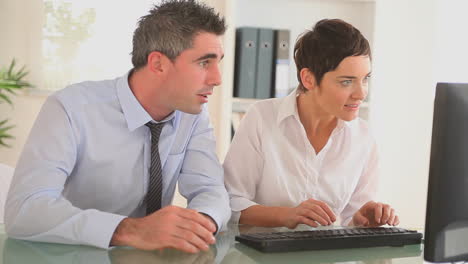 Businessmpartners-sitting-a-desk