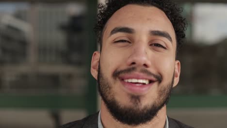 Close-up-shot-of-smiling-handsome-young-man-with-bristle