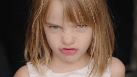 portrait of a little girl making an angry expression