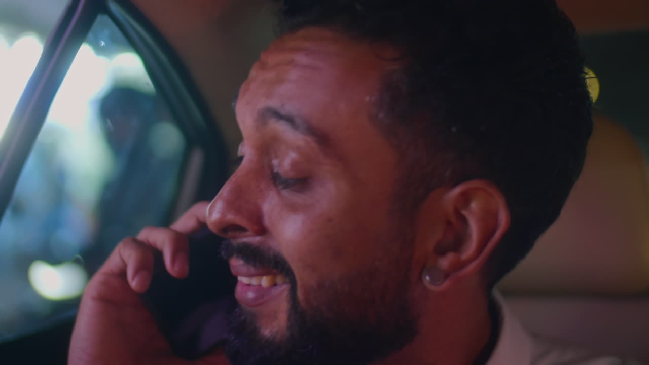 Businessman Talking on Phone in Taxi at Night