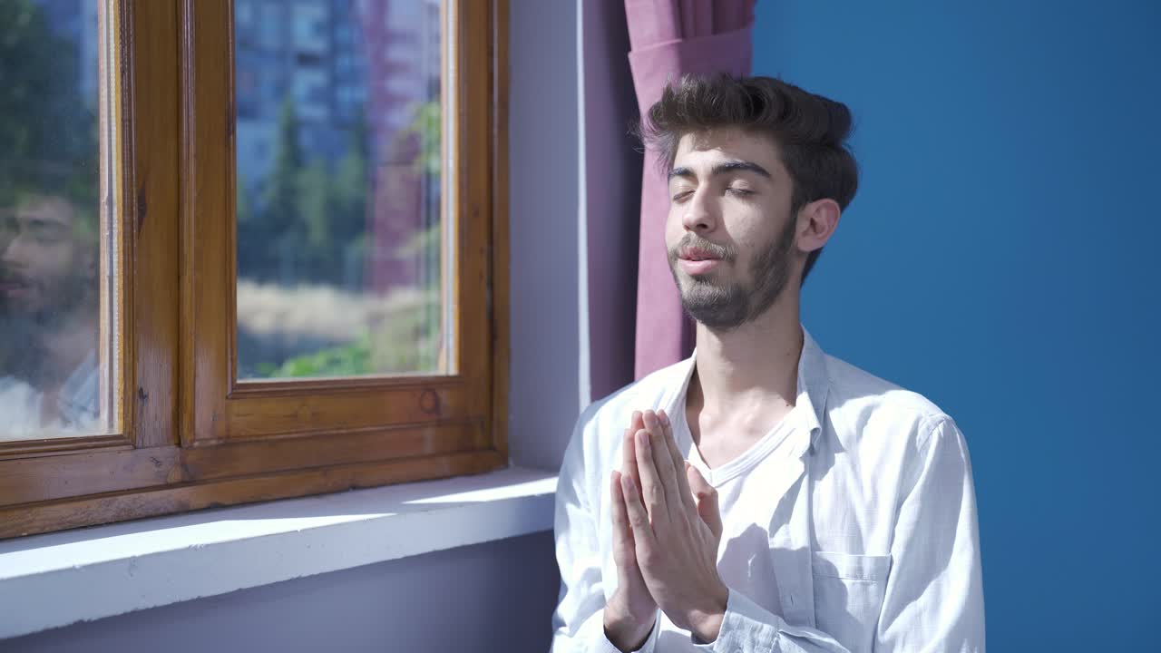 창문 앞에서 명상하는 남자.