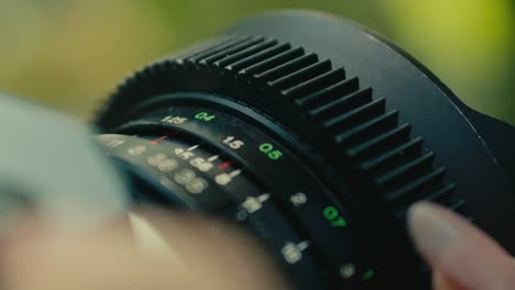 close up of old retro vintage film camera while a female hand turning the focus wheel