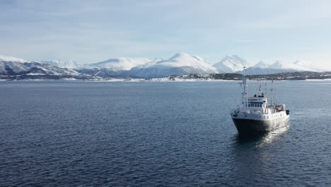 Aerial-Drone-view-Polar-Fjord-Cruise-Ship-Sailing-in-the-Arctic-Sea-in-Tromso,-Norway