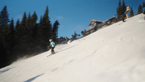 4k tracking of group of skiers going downhill at fast pace on a sunny winter day in a norwegian mountain ski resort