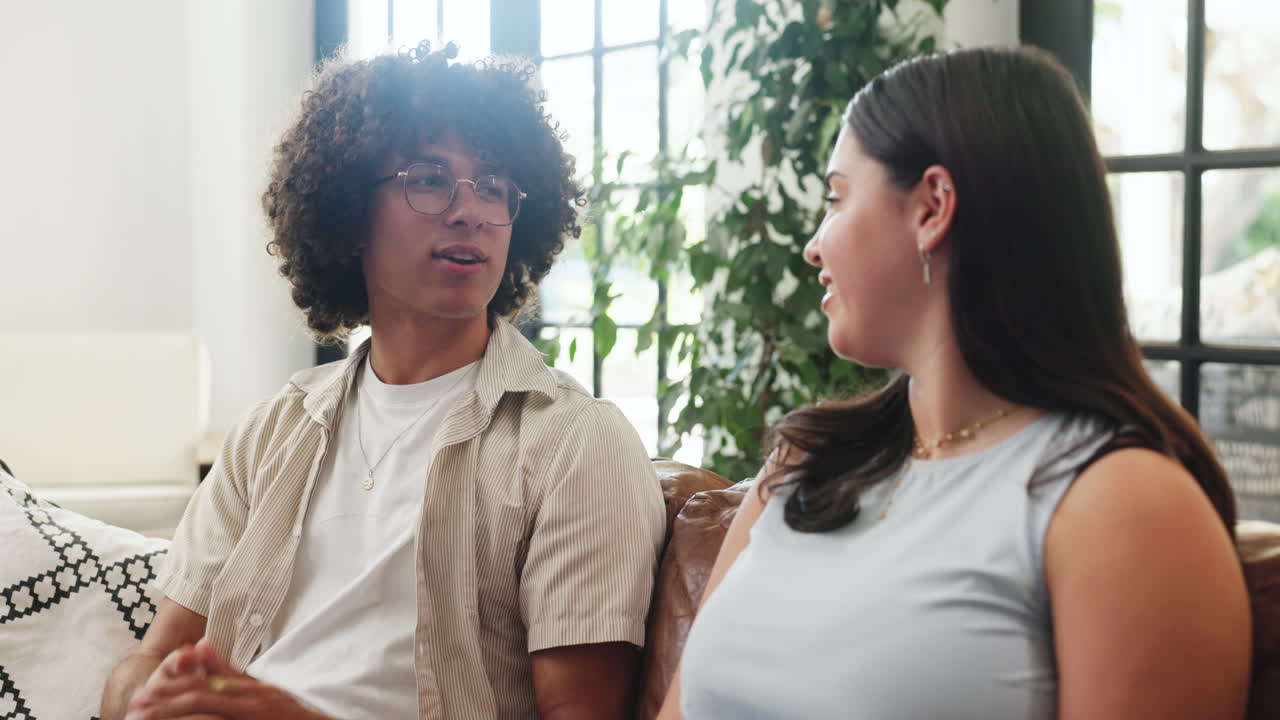 Young Man and Woman Having a Casual Conversation on a Couch