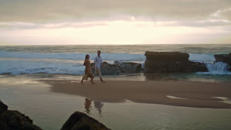 affectionate couple going sea shore wide shot. people enjoying romantic time