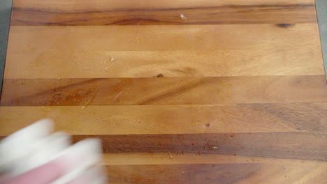 frozen food meal container being picked up and the table surface being cleaned with a cloth