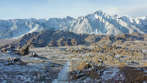 rural road and majestic mountain landscape, aerial drone fly forward view