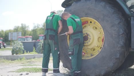 farmer mechanic repairing tractor. open tractor hood, engine. repair agricultural technology