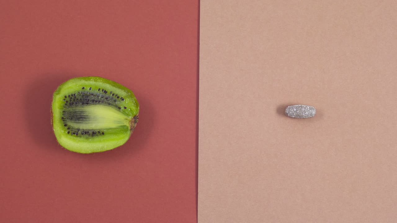 Natural supplement pills or multivitamins changed with different vegetables and fruits Stop motion
