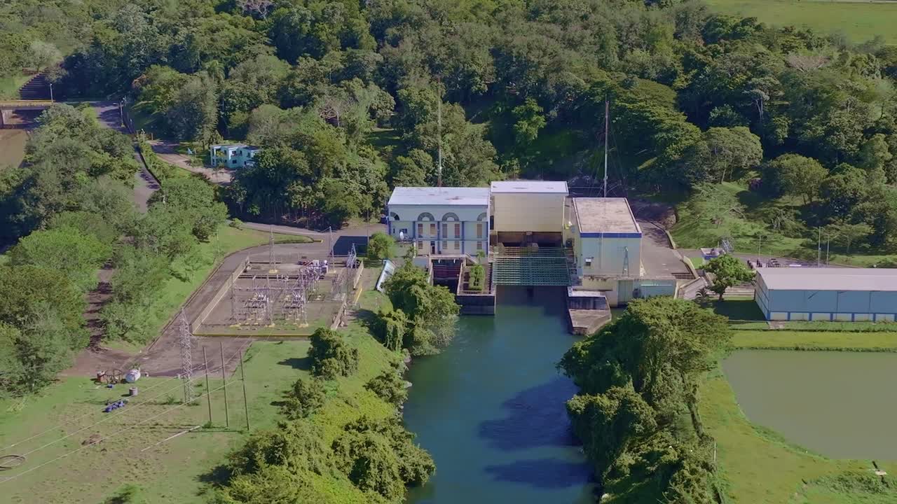 Hydroelectric power station, surrounding lush greenery, ideal for renewable energy and industrial footage, Hatillo dam in Dominican Republic. Aerial drone