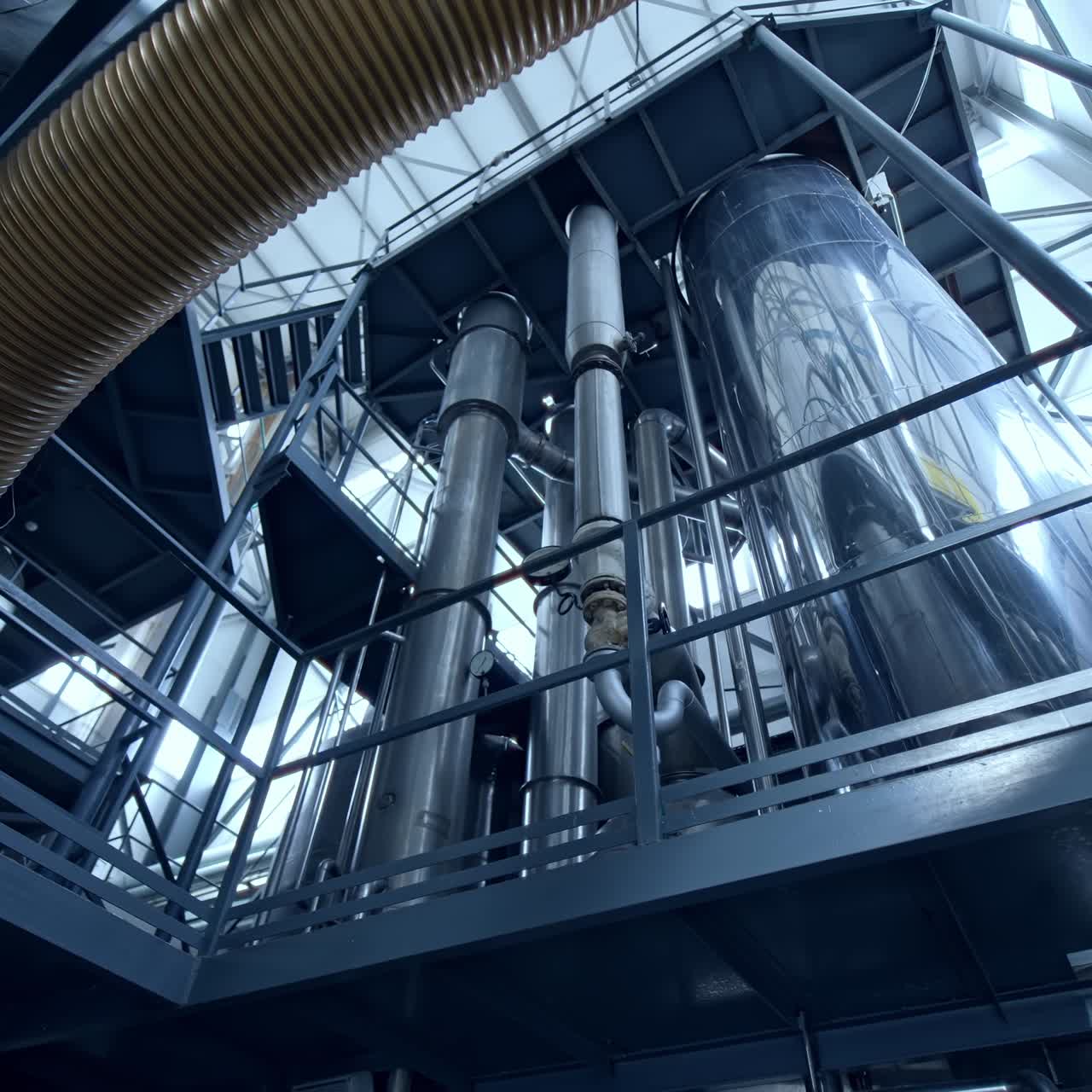 New metal industry inside. Dairy production plant with stainless tubes. Interior of modern milk factory. View from below