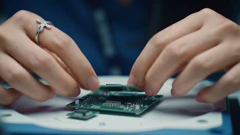 hands carefully assemble a circuit board in a tech workshop, showcasing skills in electronics and precision engineering. the environment highlights a focus on technology and innovation.