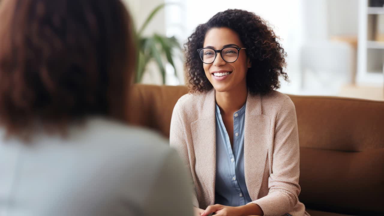 Two women in a counseling session, shot from a side angle