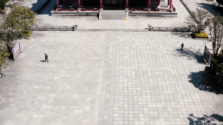 Aerial: tourist walking down steps to Three Pagodas Buddhist temple, Dali, China
