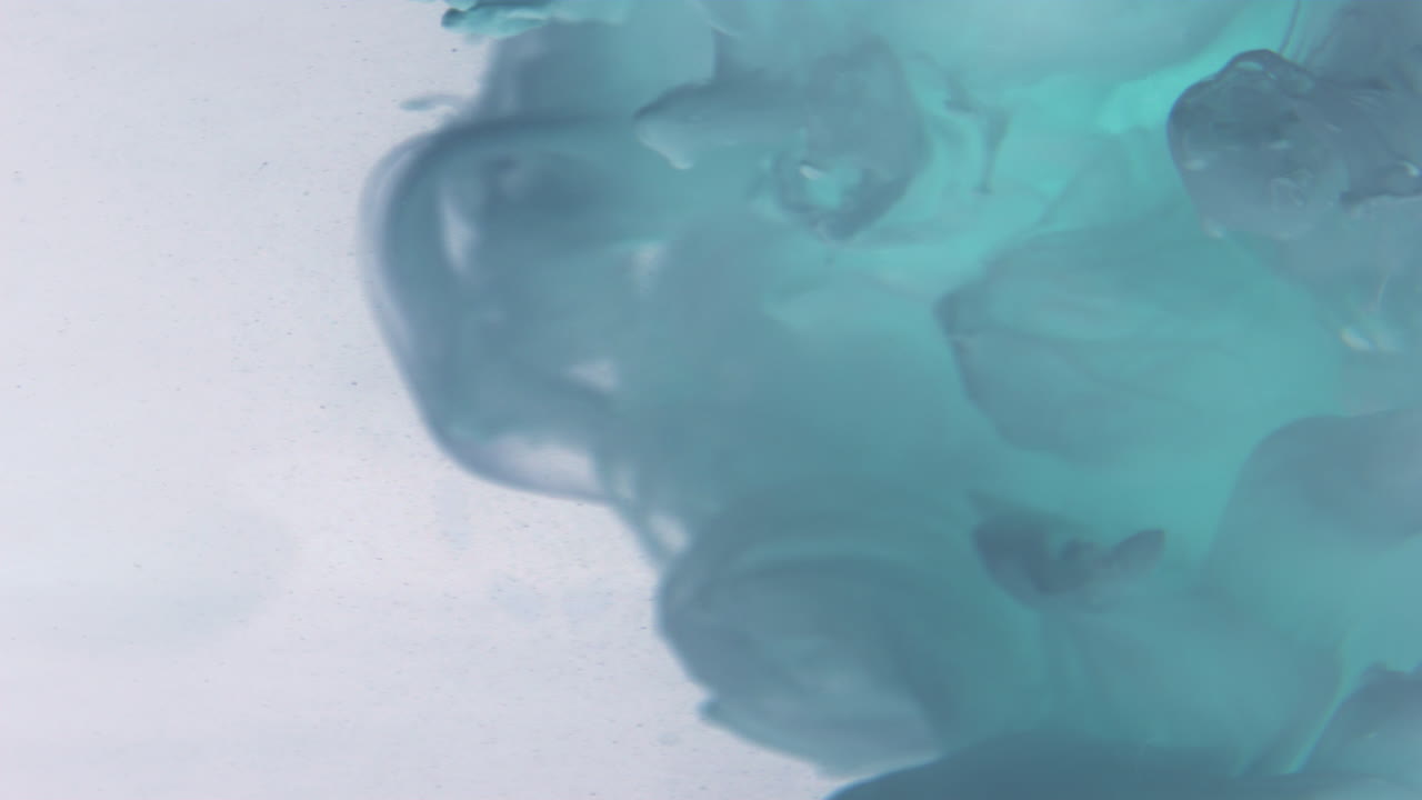 Teal Ink Swirls in Water