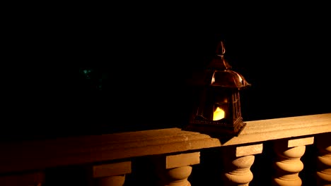 retro style lantern at night. beautiful colorful illuminated lamp at the balcony in the garden. selective focus